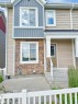 Multi-level facade featuring stone veneer accents, vertical board and batten siding, and horizontal siding - 23 1508 105 Street, Edmonton, AB 