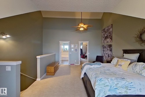 Carpeted bedroom with vaulted ceilings and a ceiling fan - 14412 98 Street, Edmonton, AB - Indoor Photo Showing Bedroom