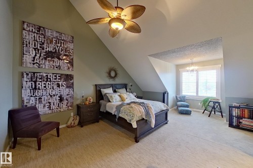 Carpeted room featuring an angled ceiling and a ceiling fan with integrated lighting - 14412 98 Street, Edmonton, AB - Indoor Photo Showing Bedroom