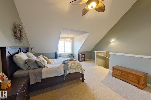 Spacious room featuring vaulted ceilings, a ceiling fan with integrated lighting, and neutral-toned carpeting - 14412 98 Street, Edmonton, AB - Indoor Photo Showing Bedroom