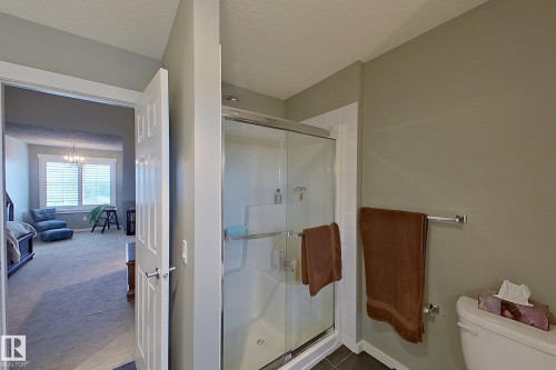 Glass-enclosed shower with white tiled surround and chrome hardware - 14412 98 Street, Edmonton, AB - Indoor Photo Showing Bathroom