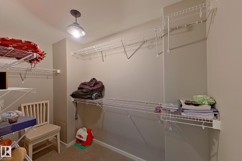 Walk-in closet featuring wire shelving systems, neutral wall paint, and recessed lighting - 14412 98 Street, Edmonton, AB - Indoor With Storage