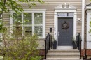 Inviting front entry featuring a paneled door, decorative door surround, transomed window, and stone steps with wrought iron railings - 14412 98 Street, Edmonton, AB  - Outdoor With Facade 