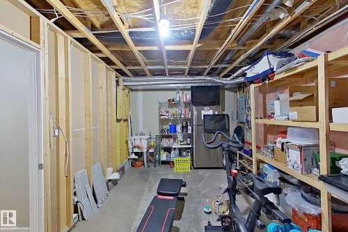 Unfinished basement space featuring exposed wood framing, concrete flooring, and visible overhead utilities - 14412 98 Street, Edmonton, AB - Indoor Photo Showing Basement
