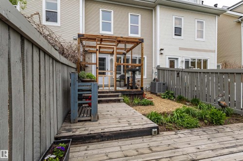 Multi-level wood decking with integrated lighting, framed by a stained wood privacy fence - 14412 98 Street, Edmonton, AB - Outdoor With Deck Patio Veranda With Exterior