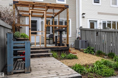 Rear patio featuring a screened enclosure with wood framing, providing an outdoor extension to the interior space - 14412 98 Street, Edmonton, AB - Outdoor With Deck Patio Veranda