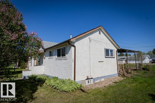 White stucco exterior with a brown shingled roof and brown trim - 5218 52 Ave, St. Paul Town, AB - Outdoor With Exterior