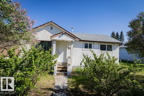 Stucco exterior with an asphalt shingle roof - 5218 52 Ave, St. Paul Town, AB - Outdoor