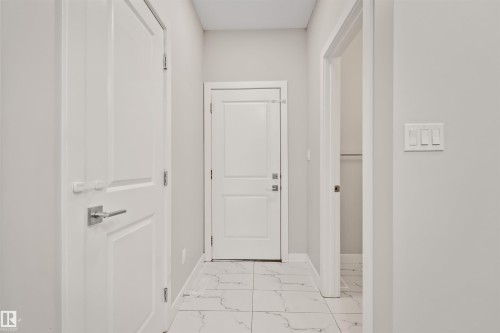 Hallway with light gray walls and white trim - 383 Charlesworth Drive, Edmonton, AB 