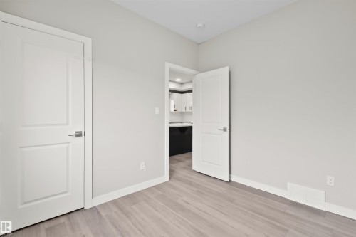 Light gray painted walls with wood-finish flooring - 383 Charlesworth Drive, Edmonton, AB 