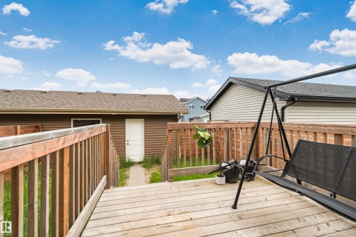 Expansive outdoor wood-finish deck with a wooden railing system - 383 Charlesworth Drive, Edmonton, AB 
