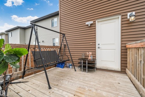 Expansive wooden deck with wooden privacy fence and exterior lighting fixture - 383 Charlesworth Drive, Edmonton, AB 