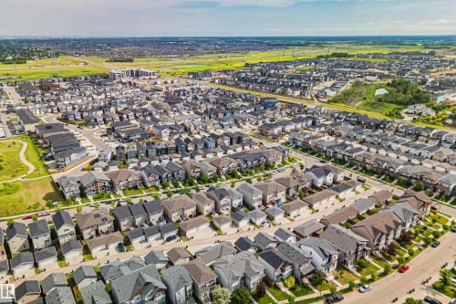 Aerial perspective of a developed residential area featuring multiple single-family homes with pitched roofs, individual driveways, and landscaped yards - 383 Charlesworth Drive, Edmonton, AB 