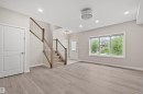 Light wood-finish flooring throughout the main living area - 383 Charlesworth Drive, Edmonton, AB 