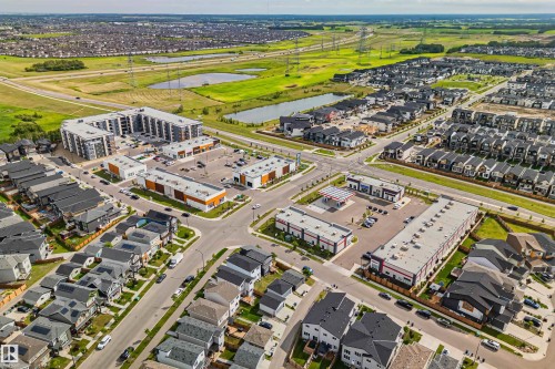 Aerial perspective showcasing a modern residential neighborhood with a variety of housing styles - 383 Charlesworth Drive, Edmonton, AB 
