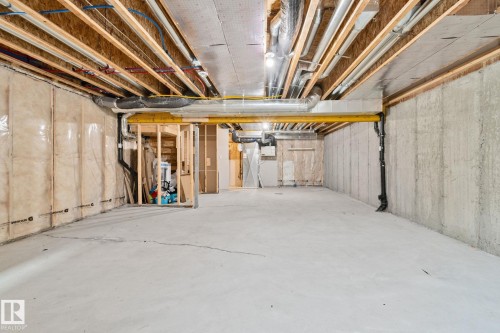 Unfinished basement featuring exposed concrete walls and flooring - 383 Charlesworth Drive, Edmonton, AB 