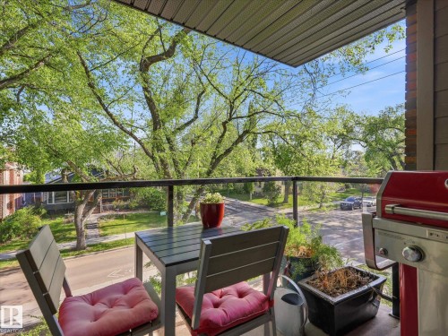 Private balcony featuring a glass railing and slat wood ceiling - 301 10003 87 Avenue, Edmonton, AB - Outdoor With Deck Patio Veranda With Exterior