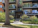 Multi-story building exterior featuring balconies with glass railings, a covered main entrance with steps, and ground-level landscaping - 301 10003 87 Avenue, Edmonton, AB  - Outdoor With Facade 