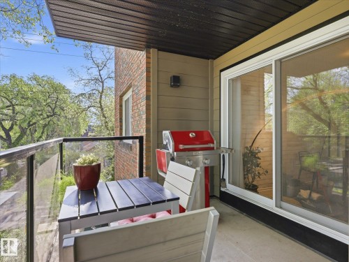 Private balcony featuring a concrete floor, glass and metal railing, and a sliding glass door - 301 10003 87 Avenue, Edmonton, AB - Outdoor With Exterior