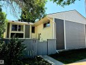Multi-level exterior with mixed siding, featuring horizontal panels and decorative shingles - 600 Willow Crest, Edmonton, AB 