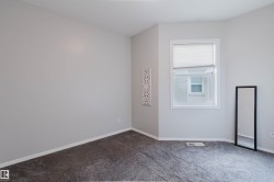 Room featuring light gray walls, gray carpeting, and white trim - 
