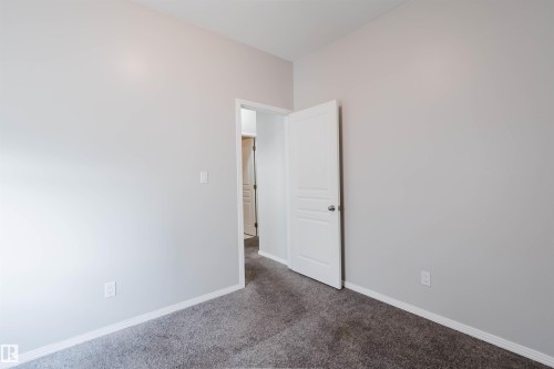 Neutral gray walls with white trim and dark gray carpeting - 202 10939 82 Avenue, Edmonton, AB 