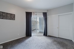 Neutral tone walls with dark gray carpeting - 