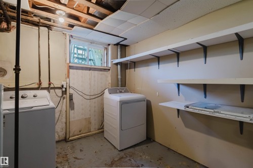 Utility area featuring exposed joist ceiling, an egress window, and wall-mounted shelving - 9606 163 Street, Edmonton, AB 