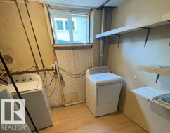Laundry area featuring wood-finish flooring and a window - 