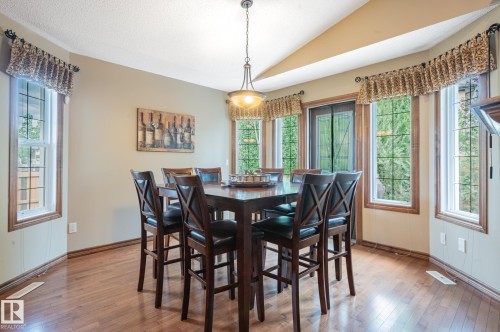 Dining area featuring wood-finish flooring and a vaulted ceiling - 19 Newton Place, St. Albert, AB - Indoor Photo Showing Dining Room
