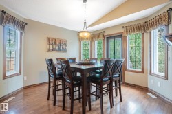 Dining area featuring wood-finish flooring and a vaulted ceiling - 