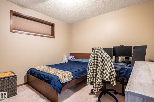 Spacious room featuring neutral wall tones, a recessed window with wood trim, and a textured ceiling - 19 Newton Place, St. Albert, AB - Indoor Photo Showing Bedroom