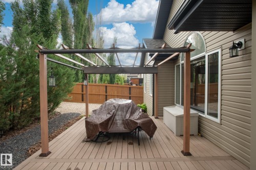 Spacious rear deck featuring wood-finish composite decking and a pergola structure - 19 Newton Place, St. Albert, AB - Outdoor With Exterior
