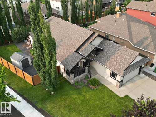 Contemporary single-family residence featuring a two-car garage, stone and stucco exterior accents, a gabled roof, and a front porch entry - 19 Newton Place, St. Albert, AB - Outdoor