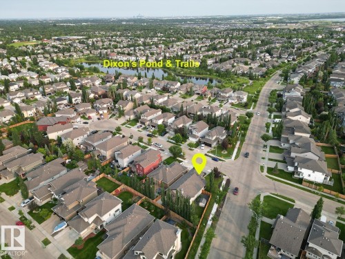 Aerial perspective showcasing a residential neighborhood with a prominent pond and trails - 19 Newton Place, St. Albert, AB - Outdoor With View