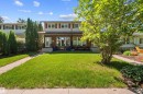 Front exterior featuring brick and siding facade, covered entry, and upper-level windows with shutters - 10940 123 Street, Edmonton, AB 