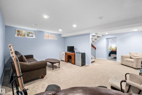 Carpeted recreation room featuring light blue walls and recessed lighting - 10940 123 Street, Edmonton, AB 