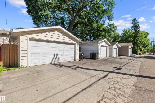 Row of detached garages with horizontal siding and paneled garage doors - 10940 123 Street, Edmonton, AB 