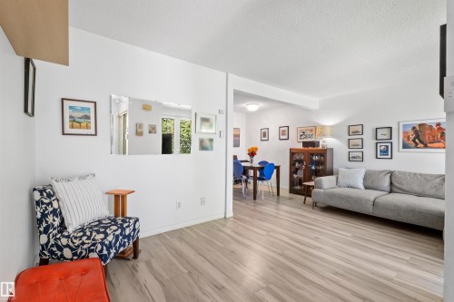 Bright interior living space featuring wood-finish flooring throughout - 10940 123 Street, Edmonton, AB 