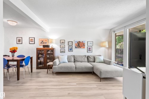 Open concept living area featuring light wood-finish flooring throughout - 10940 123 Street, Edmonton, AB 