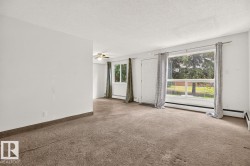 Spacious interior featuring neutral carpeting and white walls - 