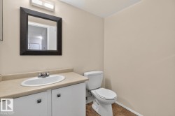 Bathroom featuring a white vanity with a tan countertop, an oval undermount sink, and a chrome faucet - 