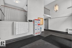 Lobby area featuring parcel lockers and individual mailboxes - 