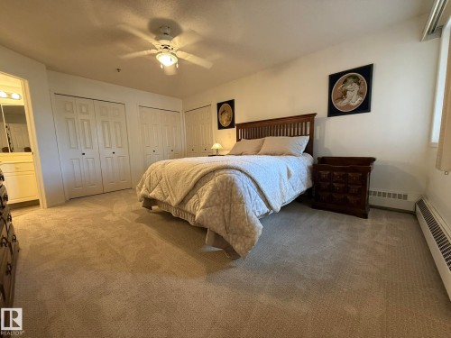 PHOTO OF THE OVERSIZED PRIMARY BEDROOM WITH 3-SEPARATE CLOSETS! - 102 10903 21 Avenue, Edmonton, AB - Indoor Photo Showing Bedroom