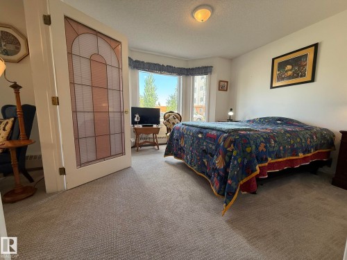 GREAT SIZED 2nd BEDROOM WITH A BAY WINDOW FOR THAT EXTRA SPACE & A FRENCH DOOR CONNECTING TO THE LIVING ROOM! - 102 10903 21 Avenue, Edmonton, AB - Indoor Photo Showing Bedroom