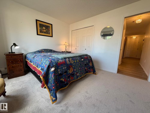 Neutral wall colors with textured carpeting - 102 10903 21 Avenue, Edmonton, AB - Indoor Photo Showing Bedroom
