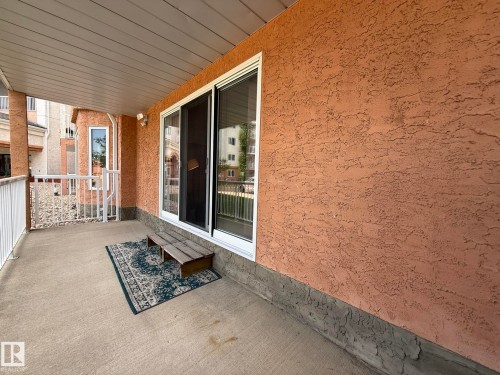 Covered patio featuring concrete flooring and a stucco exterior finish - 102 10903 21 Avenue, Edmonton, AB - Outdoor With Deck Patio Veranda With Exterior