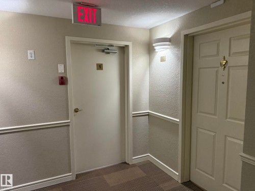 PHOTO OF YOUR UNIT #102 ENTRY DOOR! LOCATED AT THE END OF THE HALL! WHICH IS VERY QUIET DOWN THERE! - 102 10903 21 Avenue, Edmonton, AB - Indoor Photo Showing Other Room