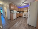 Full kitchen featuring wood-finish flooring, ample cabinetry, and a tile backsplash - 102 10903 21 Avenue, Edmonton, AB  - Indoor Photo Showing Kitchen 