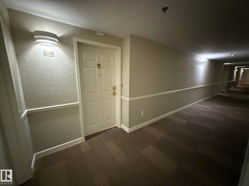 PHOTO OF THE HALLWAY WITH UPGRADED INDUSTRIAL CARPETING AND NEWLY PAINTED WALLS! - 102 10903 21 Avenue, Edmonton, AB - Indoor Photo Showing Other Room